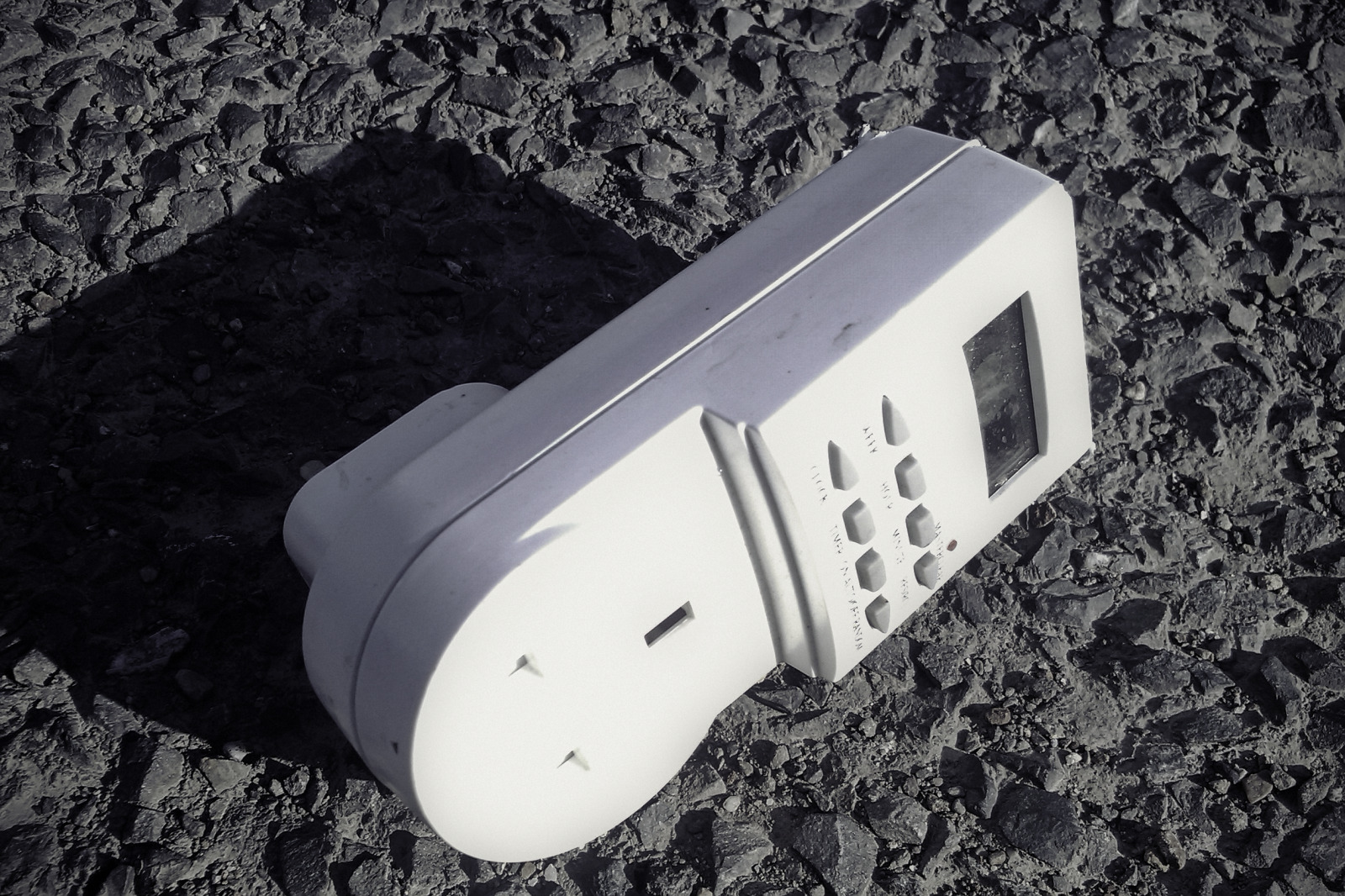 Detail of an automatic mains timer switch, discarded by a passing truck.