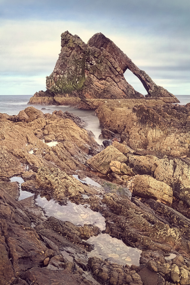 A classic view - the strong angular shape of Bow Fiddle with rock-pools in the foreground, Portknockie.

Pseudo-vintage effect courtesy of G'Mic in the Gimp. Timeless? Maybe...
