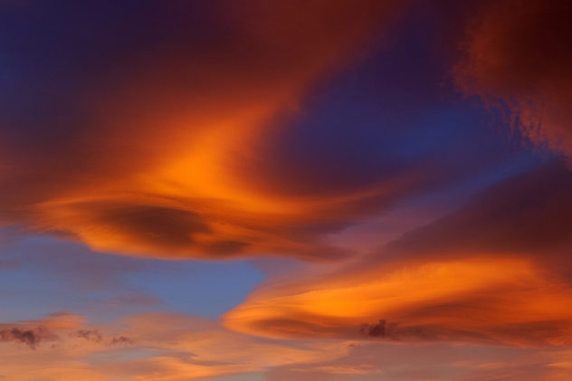 Fading lenticular clouds illuminated by a stunning sunset