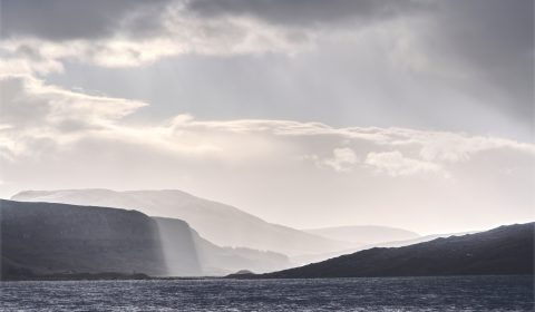 A view across Loch Assynt to the impressive formation of Inchnamph caves.

The 'Bone Caves' of Inchnadamph contain relics of Eurasian lynx, brown bear, Arctic fox, reindeer (dated to as long ago as 47,000 BP), the only evidence of polar bears so far found in Scotland, and human skeletons dated to the 3rd millennium BC