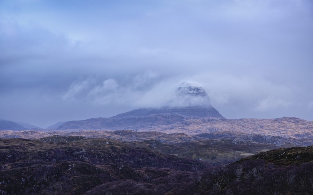 A favoured view - one of the most characteristic mountain shapes, named after the Gaelic for "tower", a cloud of mist rises and flows around the mighty Suilven.