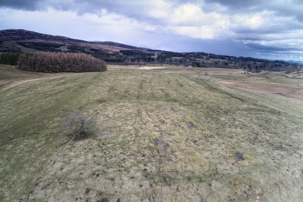 Fendoch Roman Fort and Signal Tower sit at the end of the Sma' Glen, one structure on either side of the A822, straddling the Highland Boundary Fault.

This is the camp, slightly south of the glen, looking from the more structured end (with remains of stone walls visible) along the outer walls to the east.