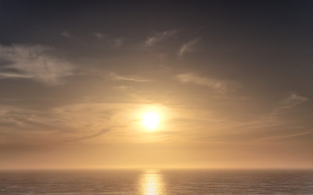 Beautiful low evening golden sunlight reflecting on the sea, on the far north Scottish coast