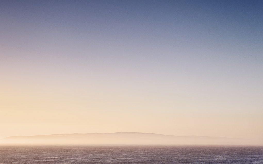 Glowing seat-mist haze: beautiful low evening golden sunlight on the far north Scottish coast: St John's Point, Caithness